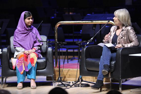 Malala Yousafzai and Jude Kelly sit on a stage